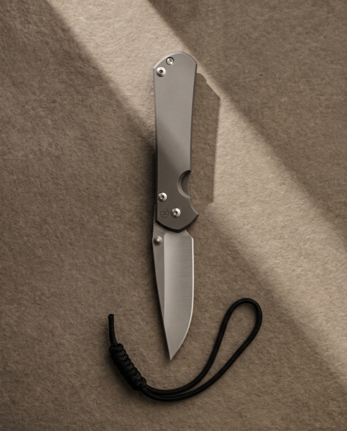 A Sebenza 31 laid on warm paper.